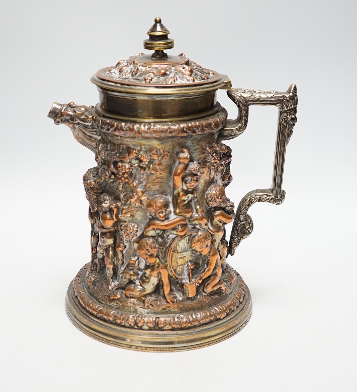 A Victorian electrotype relief putti jug with hinged cover. 24cm high